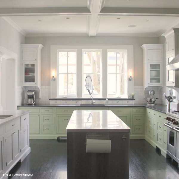 Industrial Chic Farmhouse Kitchen Inspiration with green cabinets, custom stainless island, and black stained flooring. #modernfarmhouse #kitchendesign #industrialfarmhouse #farmhousekitchen #benjaminmoorestoningtongray