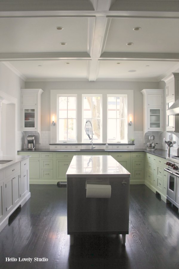 Industrial Chic Farmhouse Kitchen Inspiration with green cabinets, custom stainless island, and black stained flooring. #modernfarmhouse #kitchendesign #industrialfarmhouse #farmhousekitchen #benjaminmoorestoningtongray