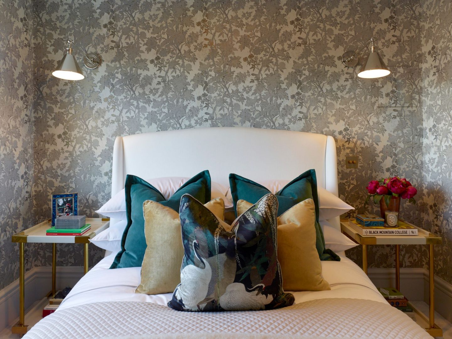 Grey Liberty of London wallpaper in bedroom with white wingback bed in London apartment. Colorful Classic Decor in London Inspired by 'Out of Africa' - come see more from Studio L London! #britishcolornial #livingroom #pinkandgreen #elegantdecor #Londonapartment #interiordesigninspiration