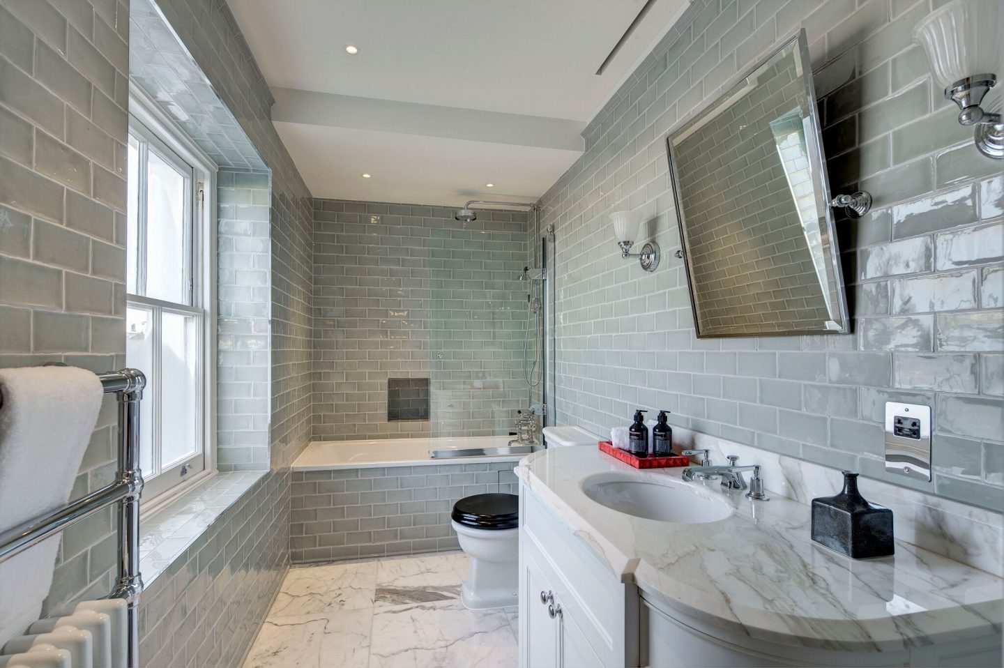 Sage green wall tiles in a luxurious bespoke bathroom designed by Studio L London.
