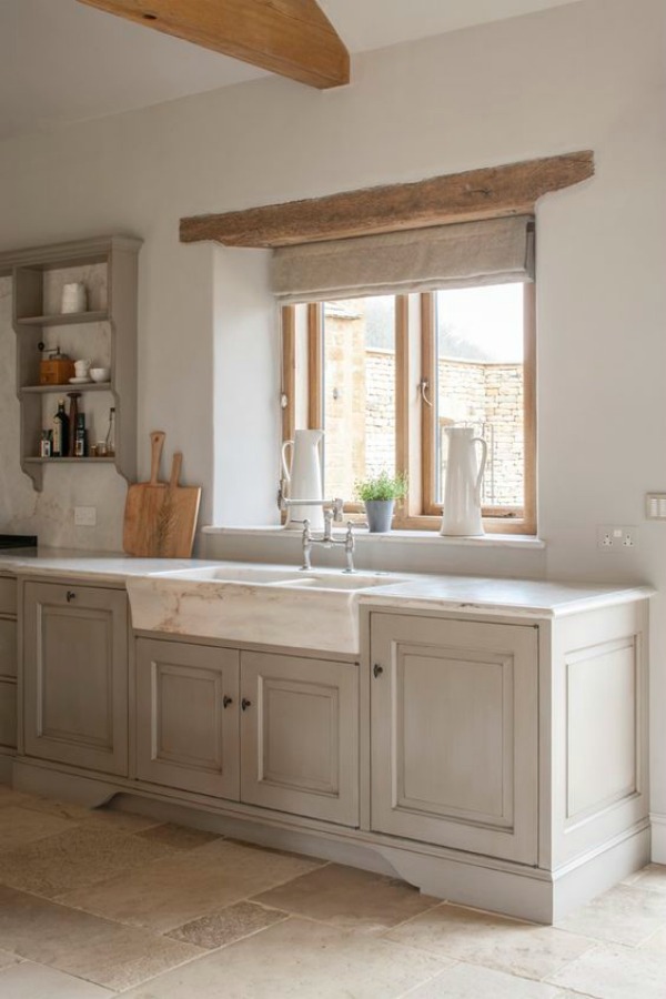 Bespoke kitchen designed by Artichoke with Flemish design influences and French farmhouse style. Marble farm sink, glazed cainbetry, and rustically natural wood beams. #frenchfarmhouse #kitchendesign #marblesink