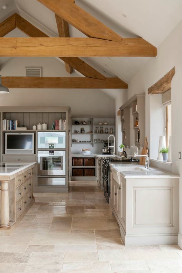 Modern rustic bespoke kitchen by Artichoke in Gloucestershire, England. Flemish design details, painted kitchen cabinetry, bronze hardware, and Bental White marble