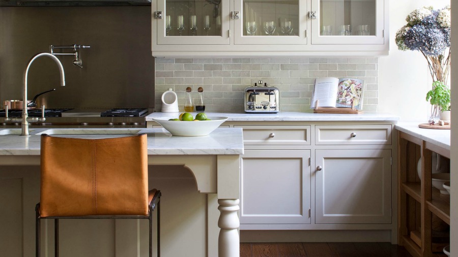 New England style coastal kitchen design by Artichoke and Michael Smith. The pot rack above the island resolved a lighting issue. #bespoke #kitchendesign #artichoke #coastalkitchen #newengland