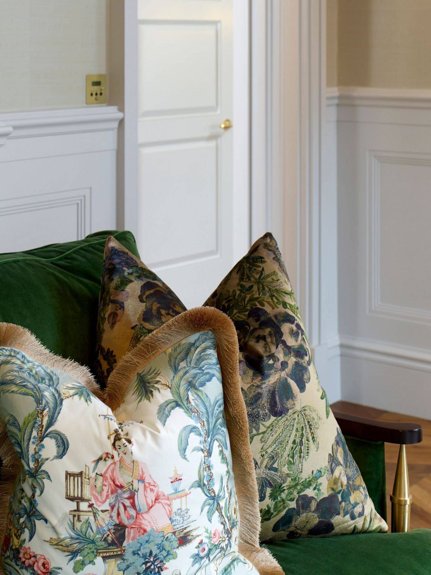 Detail of pillows on green sofa in sitting room in London apartment. Colorful Classic Decor in London Inspired by 'Out of Africa' - come see more from Studio L London! #britishcolornial #livingroom #pinkandgreen #elegantdecor #Londonapartment #interiordesigninspiration