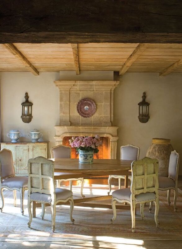 French farmhouse style dining room of Ruth Gay of Chateau Domingue. European antiques, reclaimed stone and fireplace, and exquisite antiques sing in this rustically elegant dining room. #chateaudomingue #frenchcountry #frenchfarmhouse #rusticdecor #frenchdiningroom #antiques #europeancountry #europeanfarmhouse #provencestyle