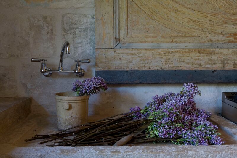 Chateau Domingue Timeless European Elegance and French farmhouse style converge in this house tour of founder Ruth Gay's home on Hello Lovely. Reclaimed stone, antique doors and mantels, and one of a kind architectural elements. #housetour #frenchcountry #frenchfarmhouse #europeanfarmhouse #chateaudomingue #rusticdecor #pamelapierce #elegantdecor #stonesink #ruthgay