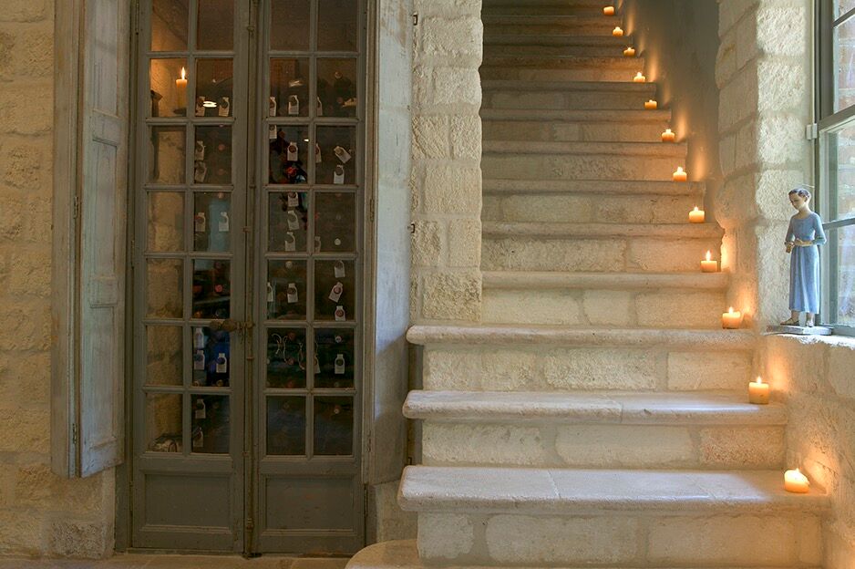 Chateau Domingue Timeless European Country Interiors in this house tour of Ruth Gay's home on Hello Lovely.  Reclaimed stone, antique doors and mantels, and one of a kind architectural elements. #housetour #frenchcountry #frenchfarmhouse #europeanfarmhouse #chateaudomingue #rusticdecor #pamelapierce #elegantdecor #staircase #stone #romantic #candlelight