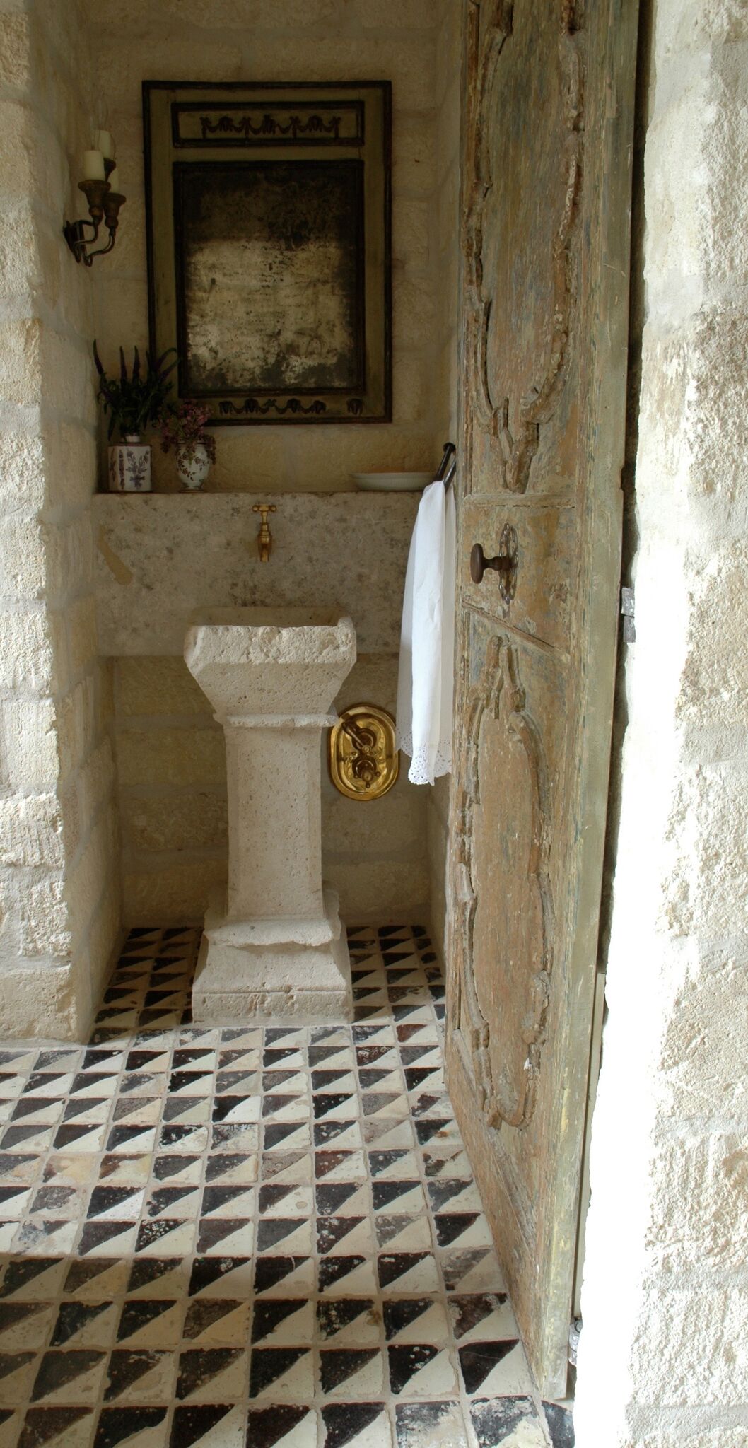 Reclaimed stone, antique doors and mantels, and one of a kind architectural elements. #housetour #frenchcountry #frenchfarmhouse #europeanfarmhouse #chateaudomingue #rusticdecor #pamelapierce #elegantdecor #bathroom #antiques #stone