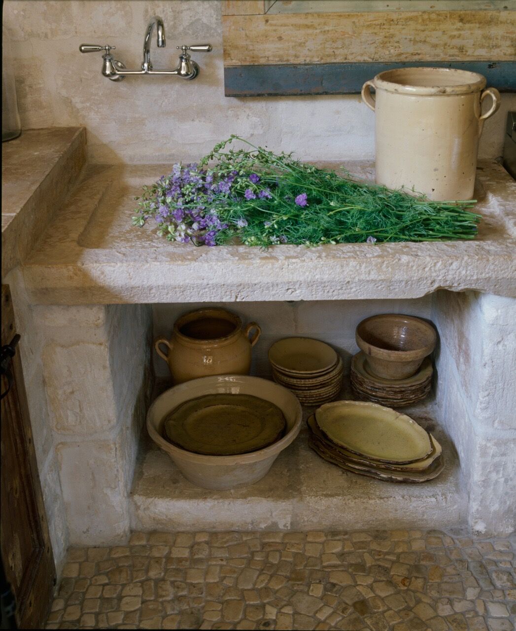 Ancient stone sink in a beautiful kitchen with reclaimed materials sourced in France and Europe - Chateau Domingue.