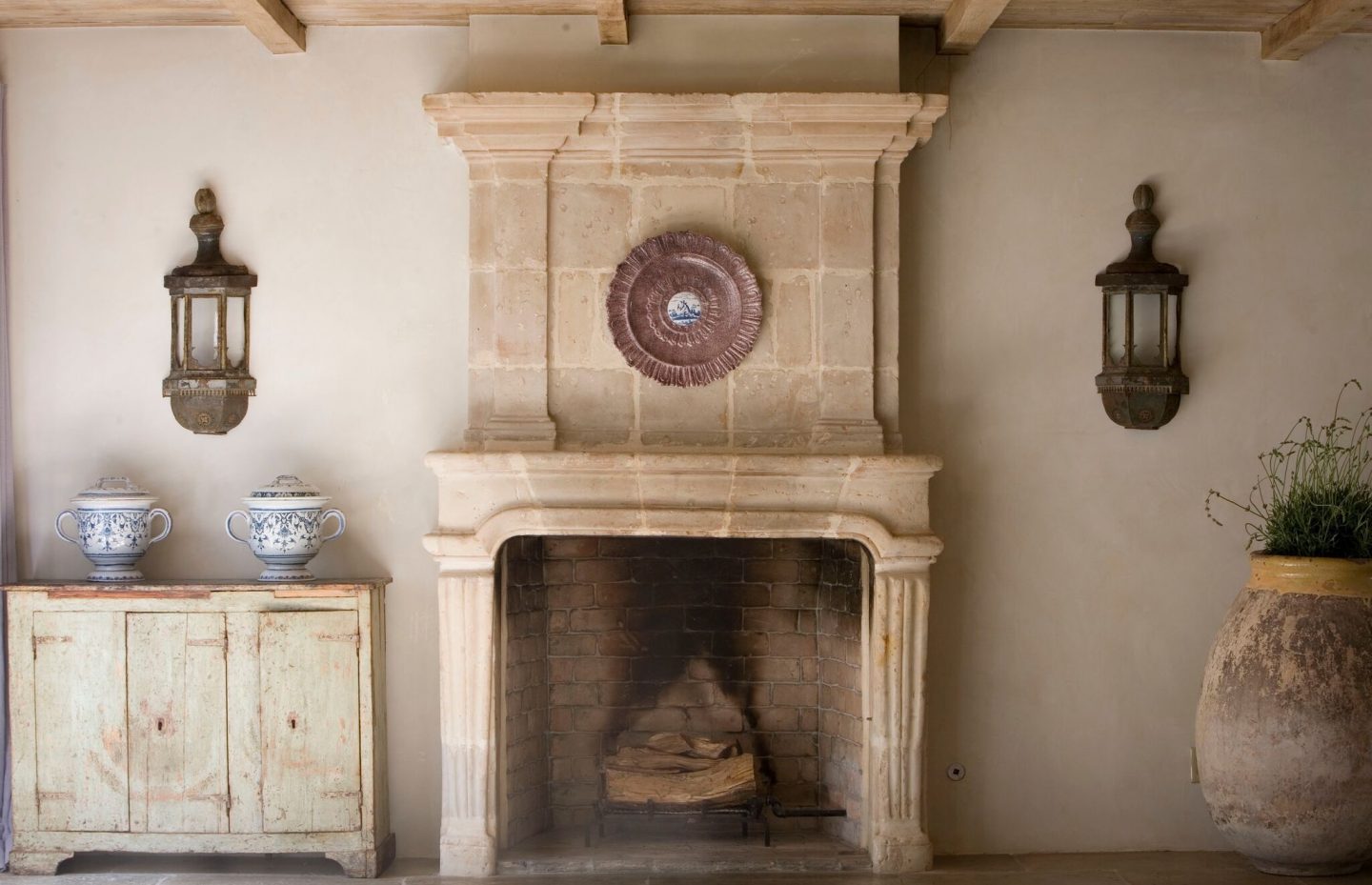 Chateau Domingue Timeless European Elegance and French farmhouse style converge in this house tour of founder Ruth Gay's home on Hello Lovely. Reclaimed stone, antique doors and mantels, and one of a kind architectural elements. #housetour #frenchcountry #frenchfarmhouse #europeanfarmhouse #chateaudomingue #rusticdecor #pamelapierce #elegantdecor #diningroom #fireplace