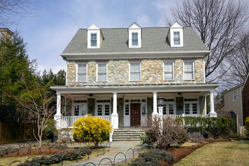 Beautiful stone exterior on charming two-story home in Maryland. Come see the dramatic Before & After: Fussy Traditional to Urban Chic! #housedesign #houseexterior #stonehouse #colonialstyle