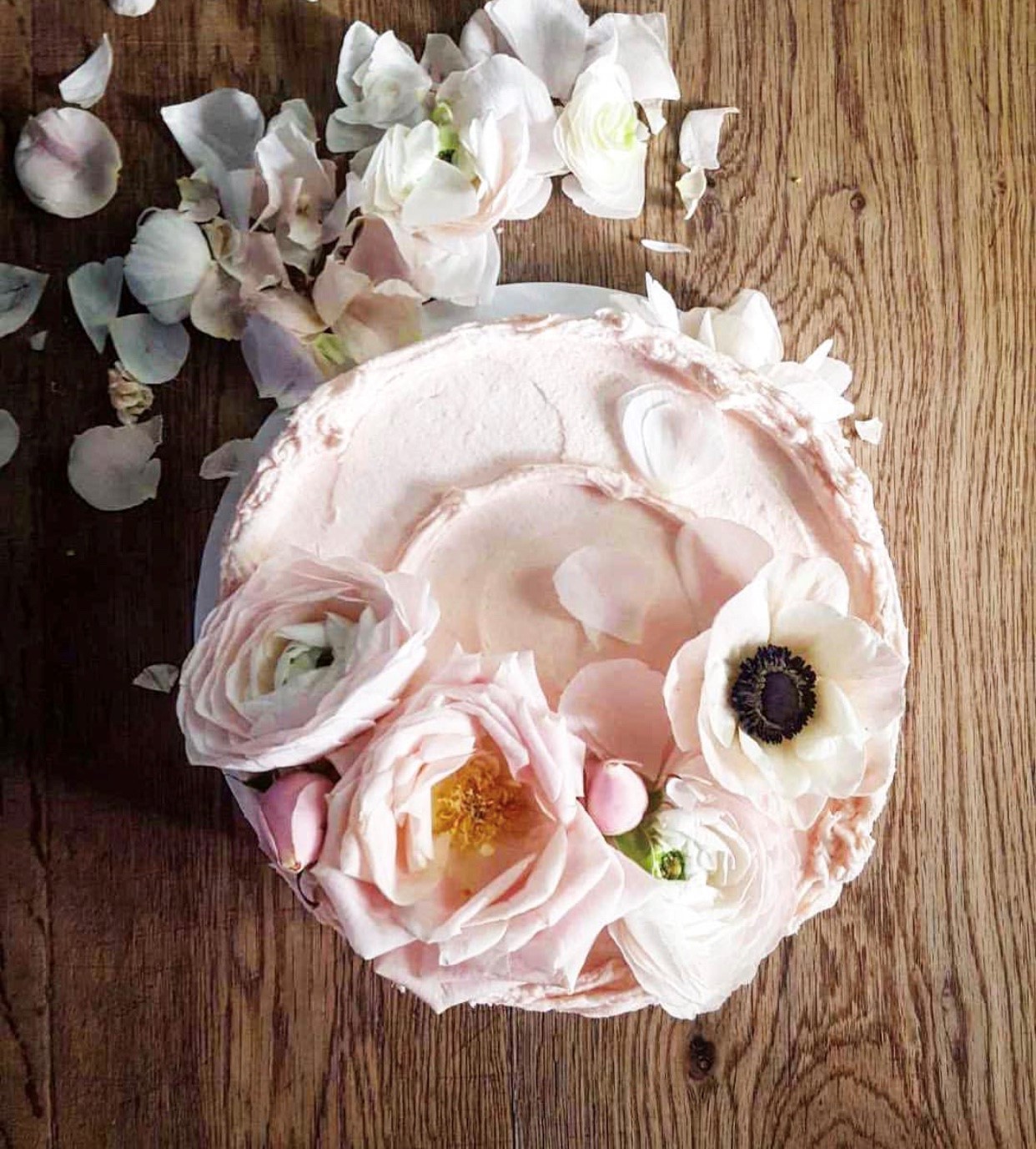 Pale pink buttercream on a cake decorated with fresh flowers. Beautiful cake styling from Violet bakery's Claire Ptak. Come see LET THEM EAT CAKE...VIOLET CAKES. #cakelover #violetbakery #violetcakes #claireptak #shabbychic #cakedecorating #letthemeatcake #bakingideas #bakingideas #cakestyling #cakequotes