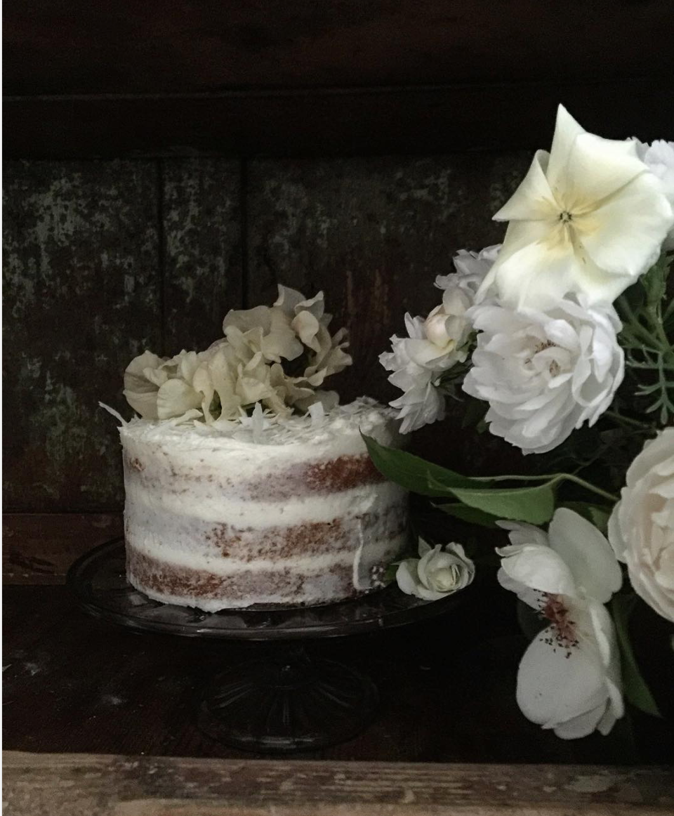 White naked cake with fresh flowers on top. Beautiful cake styling from Violet bakery's Claire Ptak. Come see LET THEM EAT CAKE...VIOLET CAKES. #cakelover #violetbakery #violetcakes #claireptak #shabbychic #cakedecorating #letthemeatcake #bakingideas #bakingideas #cakestyling #cakequotes