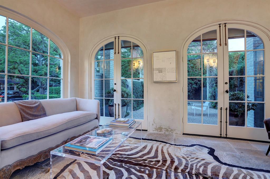 Light filled sun room. Luxurious interior design details in a Tudor Revival house renovation in Houston. Design consultant: Pam Pierce. Many reclaimed antique materials from Chateau Domingue. #housetour #oldworld #pampierce #chateaudomingue #europeanantiques #luxurioushome #interiordesignideas #Frenchcountry #limestone #reclaimedflooring #bespoke #houstonhome