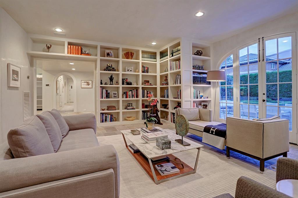 Custom built-ins in a den. Luxurious interior design details in a Tudor Revival house renovation in Houston. Design consultant: Pam Pierce. Many reclaimed antique materials from Chateau Domingue. #housetour #oldworld #pampierce #chateaudomingue #europeanantiques #luxurioushome #interiordesignideas #Frenchcountry #limestone #reclaimedflooring #bespoke #houstonhome