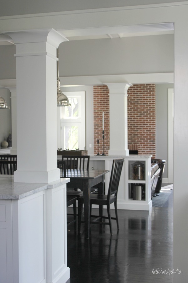 Industrial Chic Farmhouse Kitchen Inspiration with green cabinets, custom stainless island, and black stained flooring. #modernfarmhouse #kitchendesign #industrialfarmhouse #farmhousekitchen #benjaminmoorestoningtongray