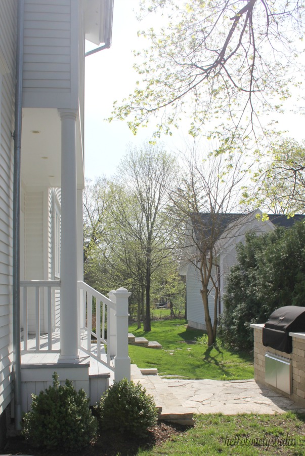 White modern farmhouse exterior with cedar siding, board and batten, metal galvalume roof, and black trim accents. Come see more! Photo by Hello Lovely Studio. #modernfarmhouse #exterior #whitefarmhouse #boardandbatten #housedesign #farmhousearchitecture #hellolovelystudio