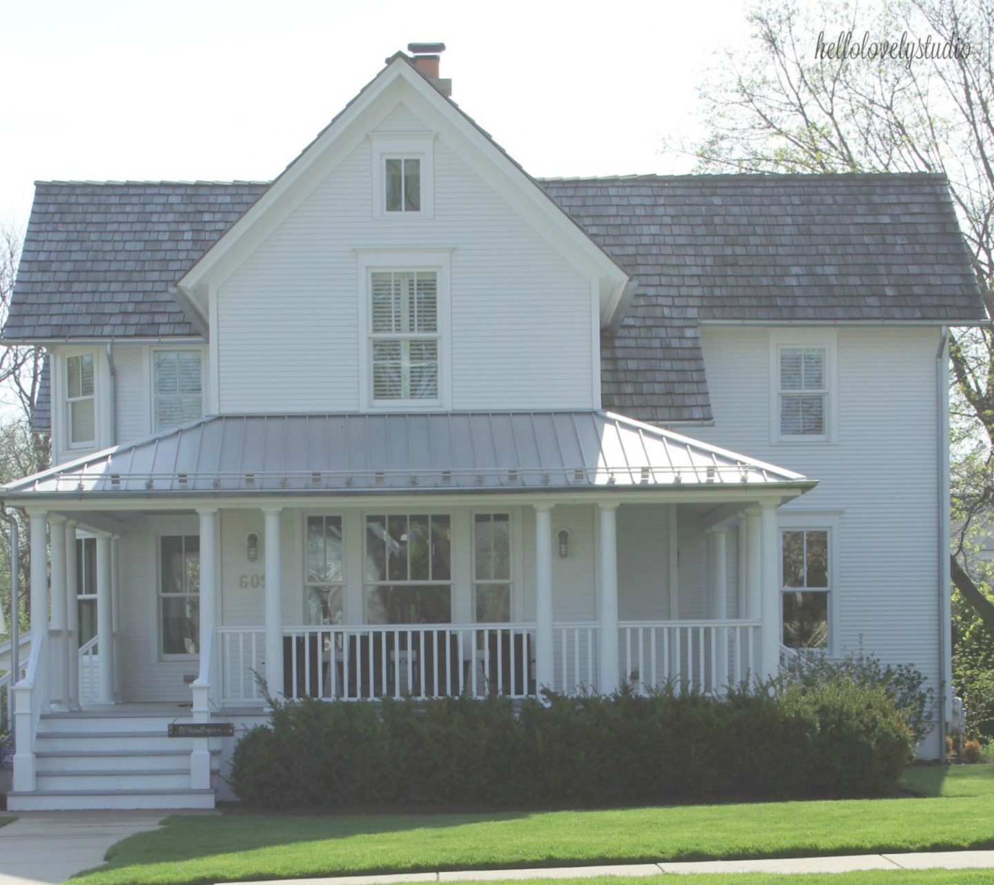 1875 Industrial Modern Farmhouse Tour. White modern farmhouse exterior with cedar siding, board and batten, metal galvalume roof, and black trim accents. 