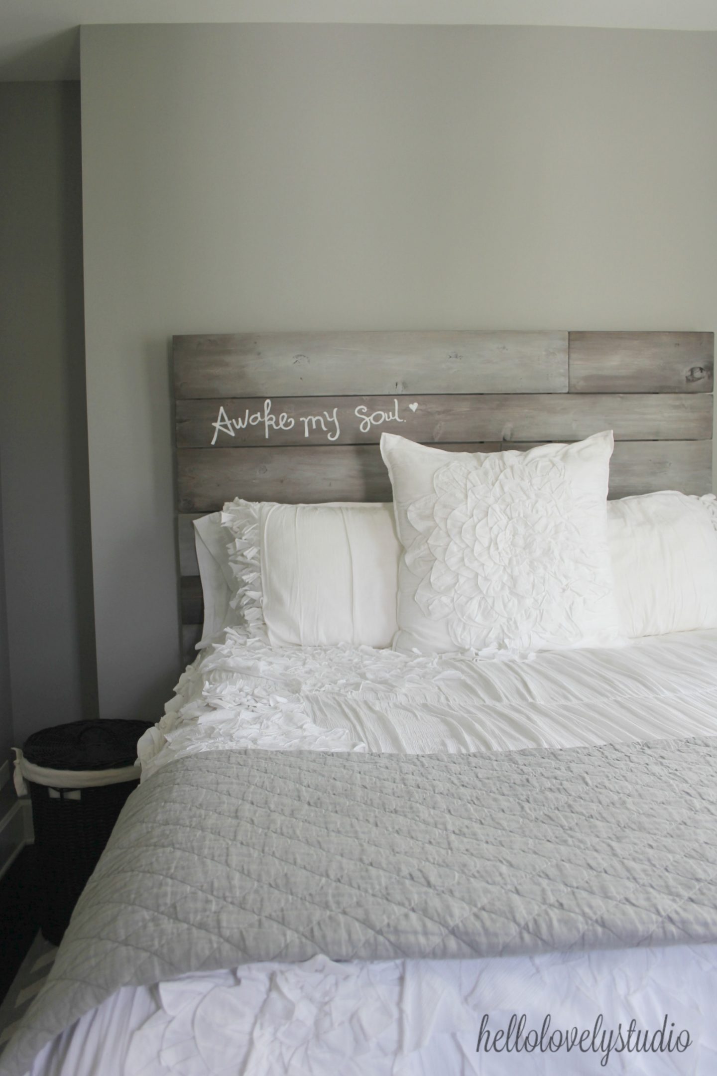 Custom barn wood headboard with "Awake My Soul" inscribed. Farmhouse bedroom inspiration. Modern Industrial Farmhouse Bedroom Design {2nd Floor Tour}. #modernfarmhouse #bedroom #industrialfarmhouse #greywalls #luxuriousfarmhouse #benjaminmooreplatinum #benjaminmoorestoningtongray