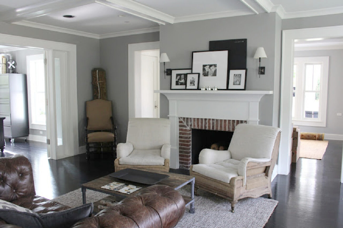 Living room with modern farmhouse decor in historic farmhouse with minimal style and grey walls. Come see the house tour! #modernfarmhouse #industrialfarmhouse #decoratingideas #farmhousestyle #benjaminmoorestoningtongray