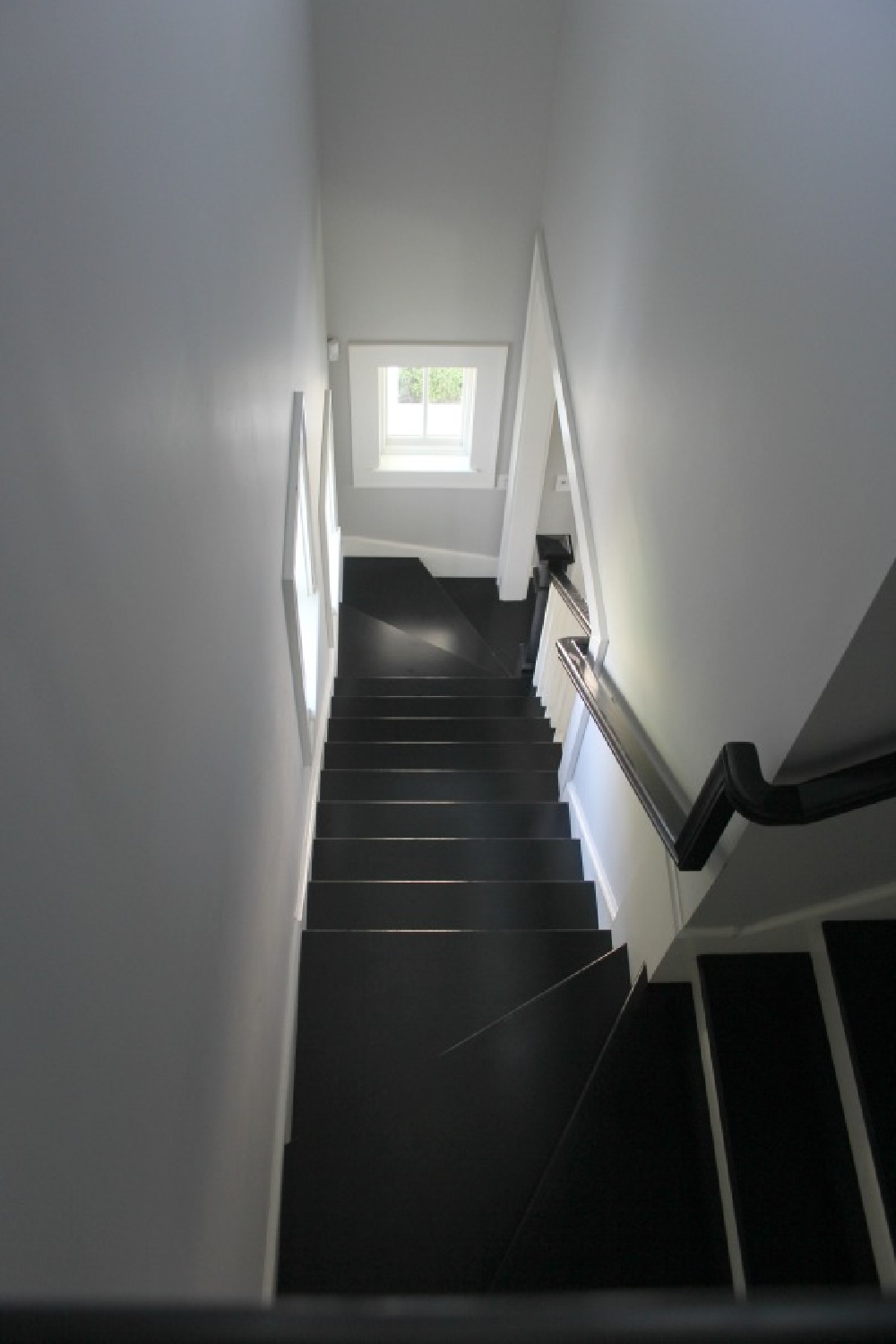 Ebony stained wood stairs in a renovated Industrial farmhouse. #staircases #blackhardwoodsdecor #benjaminmoorestoningtongray