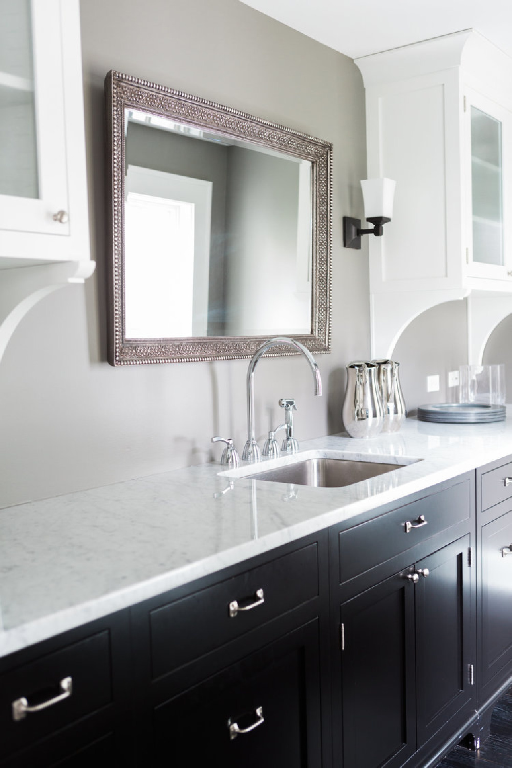 Beautiful butler pantry or scullery with black cabinetry and marble countertops  in a modern farmhouse - Hello Lovely Studio.