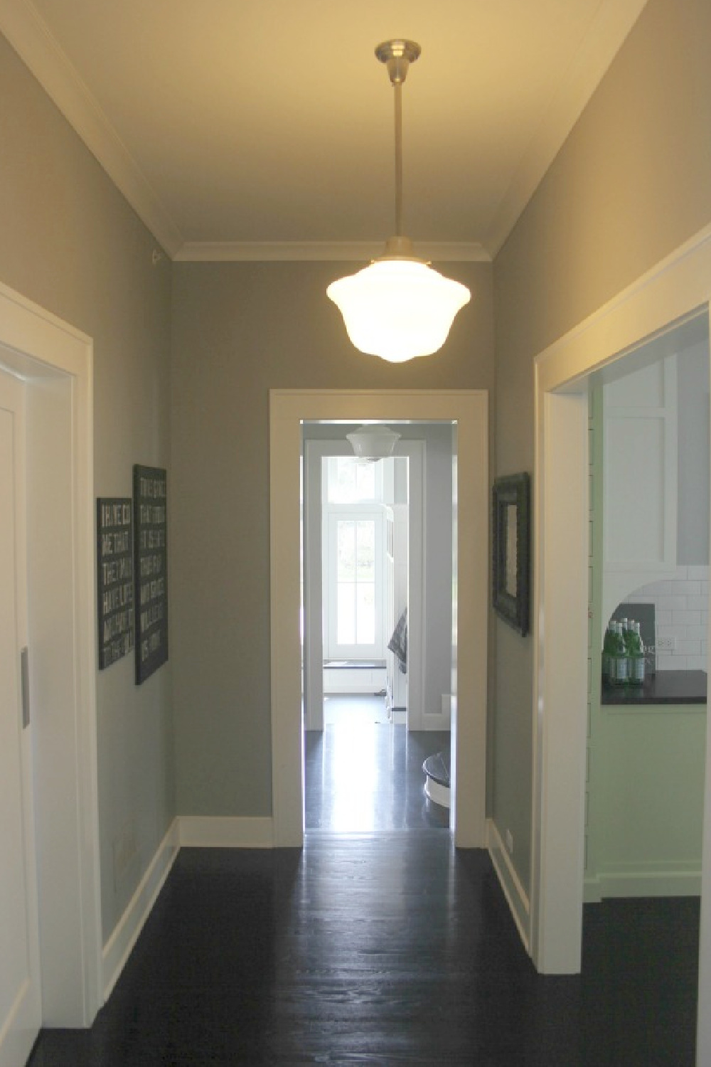 Modern farmhouse with dark black hardwood floors , white trim, and modern farmhouse style - Hello Lovely Studio.