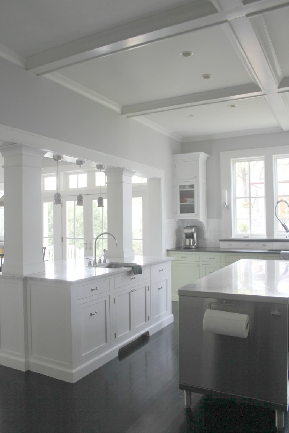 Farmhouse kitchen with two tone cabinets (green and white), soapstone countertops, and black stained hardwood floors - Hello Lovely Studio.