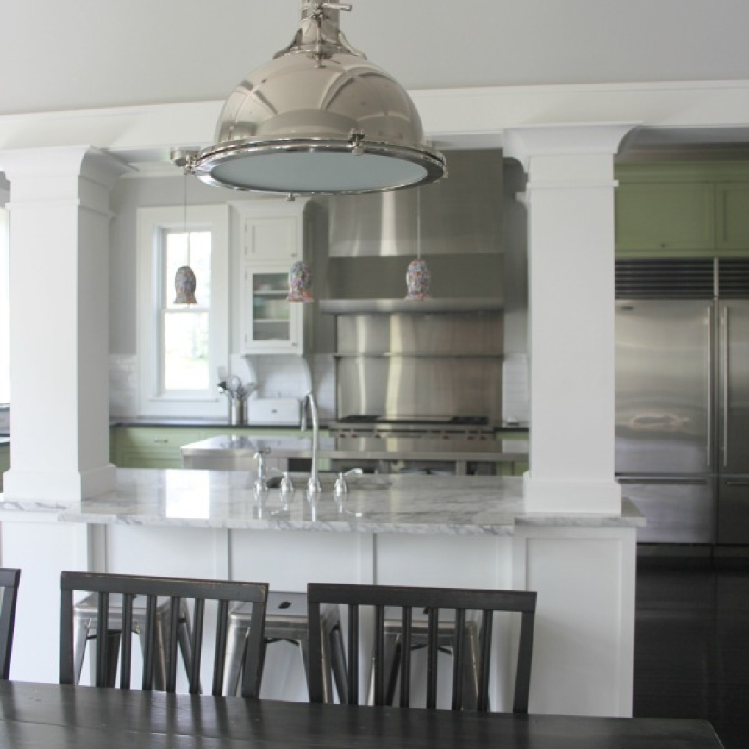 Farmhouse kitchen with two tone cabinets (green and white), soapstone countertops, and black stained hardwood floors - Hello Lovely Studio.