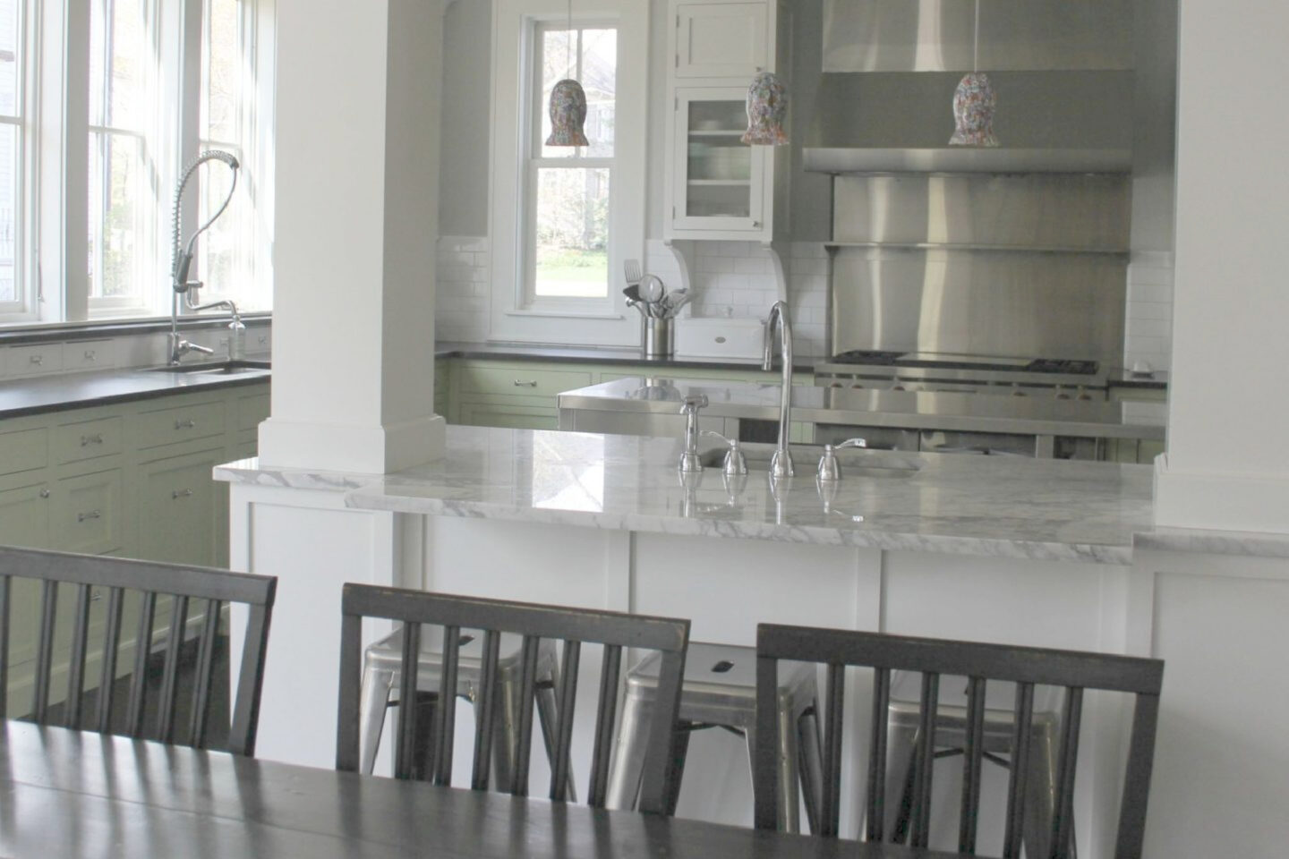 Beautiful modern farmhouse kitchen with industrial accents and commercial style appliances - Hello Lovely Studio.