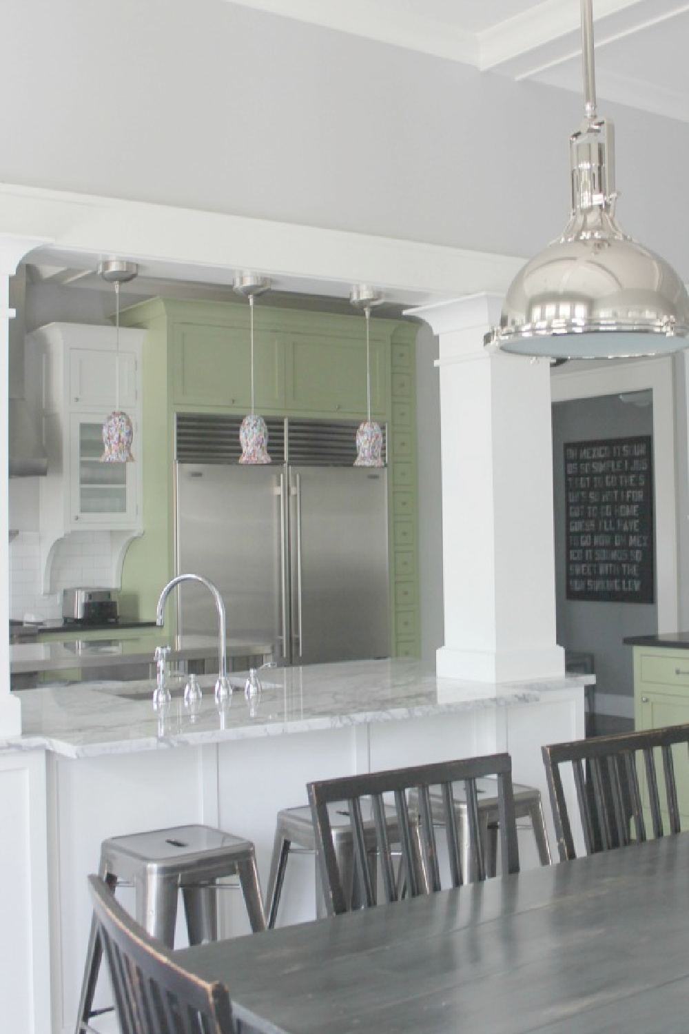 Marble breakfast bar and classic architecture in a restored modern farmhouse - Hello Lovely Studio.