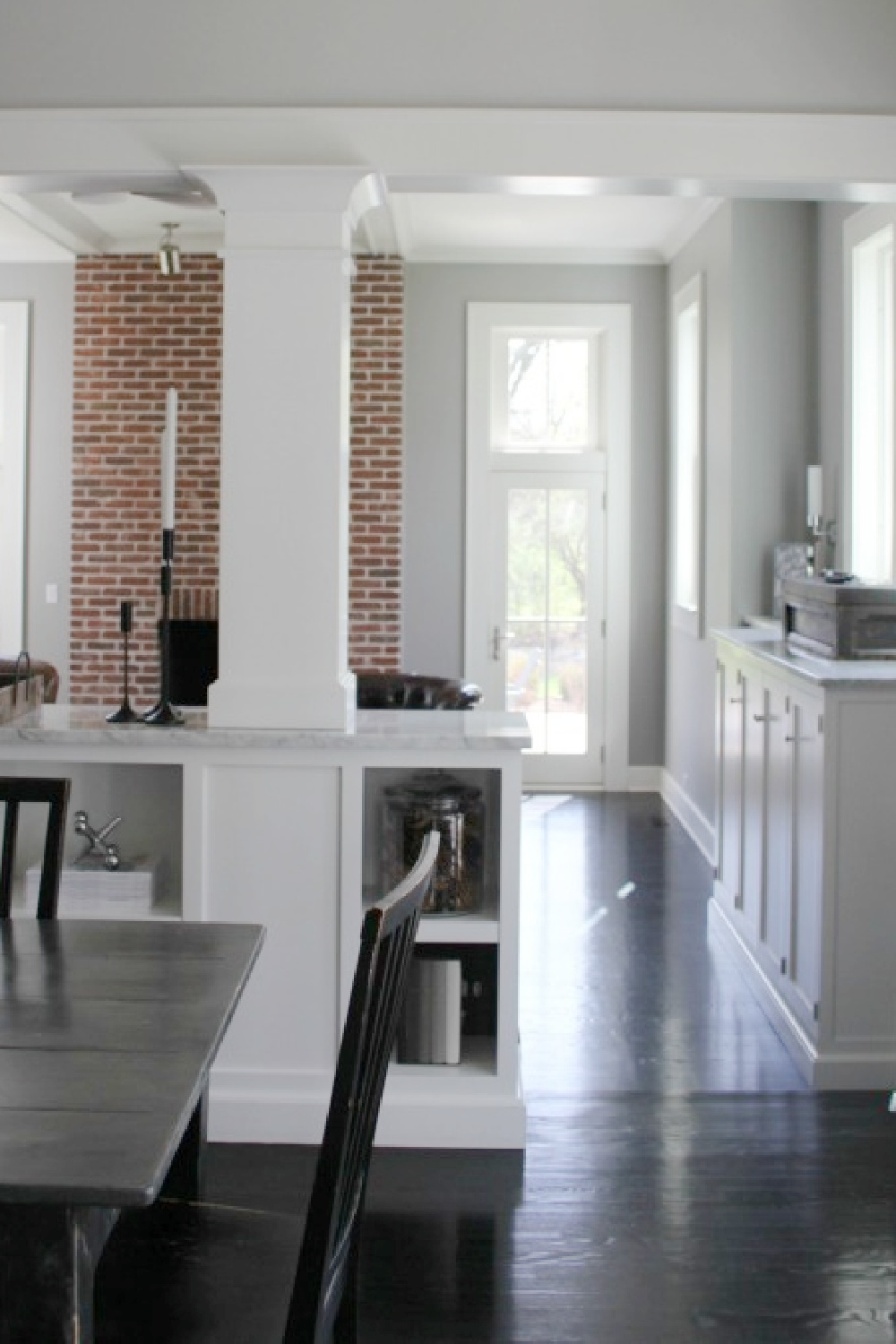 View from kitchen into family room with red brick fireplace - Hello Lovely Studio.