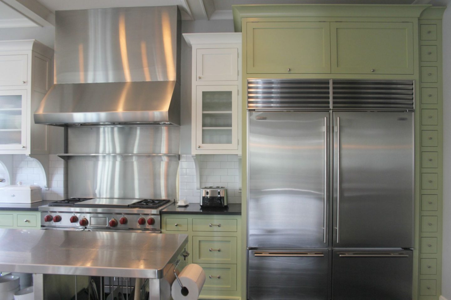 Industrial Chic Farmhouse Kitchen Inspiration with green cabinets, custom stainless island, and black stained flooring. #modernfarmhouse #kitchendesign #industrialfarmhouse #farmhousekitchen #benjaminmoorestoningtongray