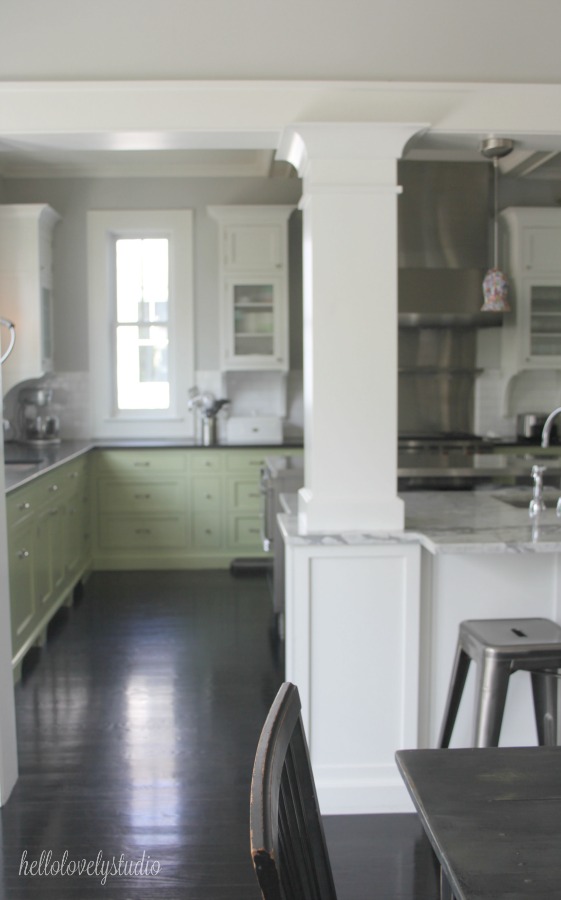 Industrial Chic Farmhouse Kitchen Inspiration with green cabinets, custom stainless island, and black stained flooring. #modernfarmhouse #kitchendesign #industrialfarmhouse #farmhousekitchen #benjaminmoorestoningtongray