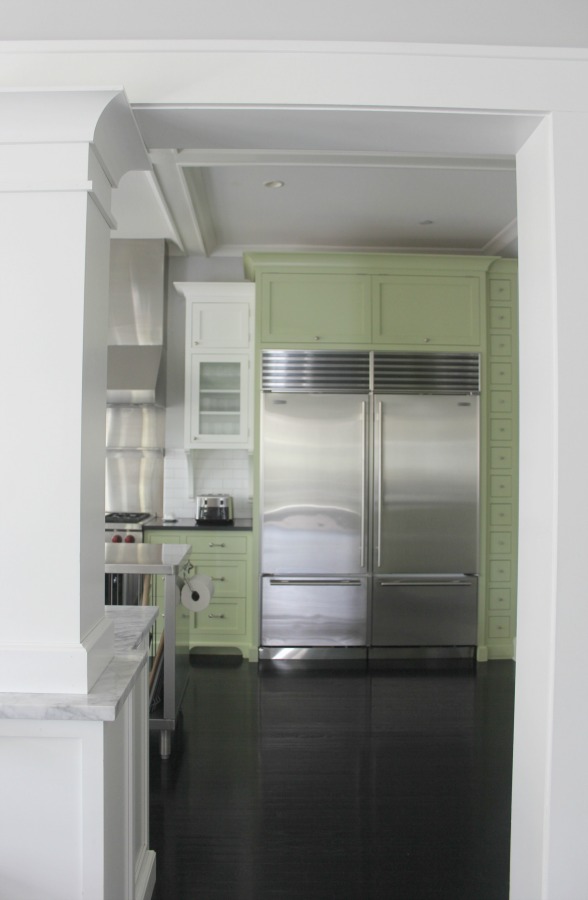 Industrial Chic Farmhouse Kitchen Inspiration with green cabinets, custom stainless island, and black stained flooring. #modernfarmhouse #kitchendesign #industrialfarmhouse #farmhousekitchen #benjaminmoorestoningtongray