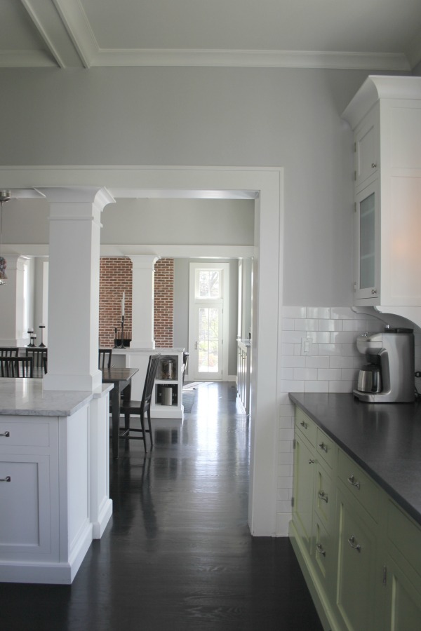 Industrial Chic Farmhouse Kitchen Inspiration with green cabinets, custom stainless island, and black stained flooring. #modernfarmhouse #kitchendesign #industrialfarmhouse #farmhousekitchen #benjaminmoorestoningtongray