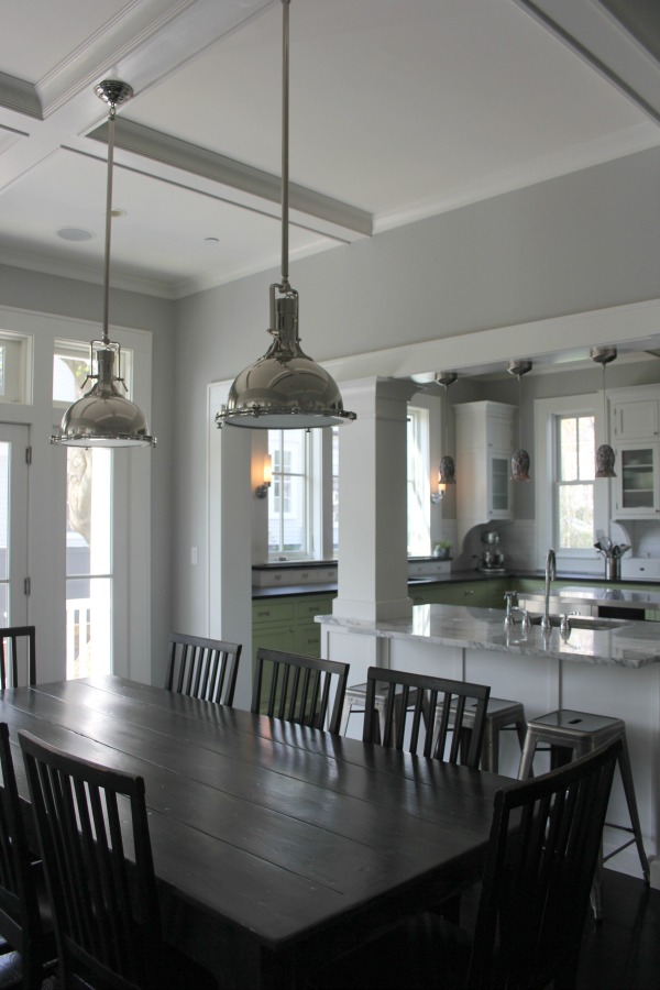 Industrial Chic Farmhouse Kitchen Inspiration with green cabinets, custom stainless island, and black stained flooring. #modernfarmhouse #kitchendesign #industrialfarmhouse #farmhousekitchen #benjaminmoorestoningtongray