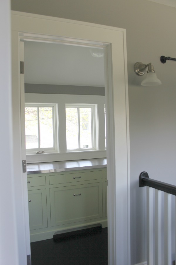 Pistachio green base cabinets in a farmhouse kitchen pantry. Farmhouse interior design inspiration for fans of industrial, modern, and traditional farmhouse house designs. This 1875 historical farmhouse in Barrington, Illinois was renovated to a high standard with superior craftsmanship and bespoke design details. Come get the medium grey paint colors! #paintcolors #greypaint #interiordesign #modernfarmhouse