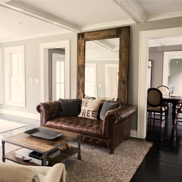 Benjamin Moore Platinum Gray paint on walls of modern farmhouse living room with tufted leather Chesterfield sofa. #benjaminmoore #platinumgray #paintcolor #graywalls #modernfarmhouse #livingroom #hellolovelystudio.