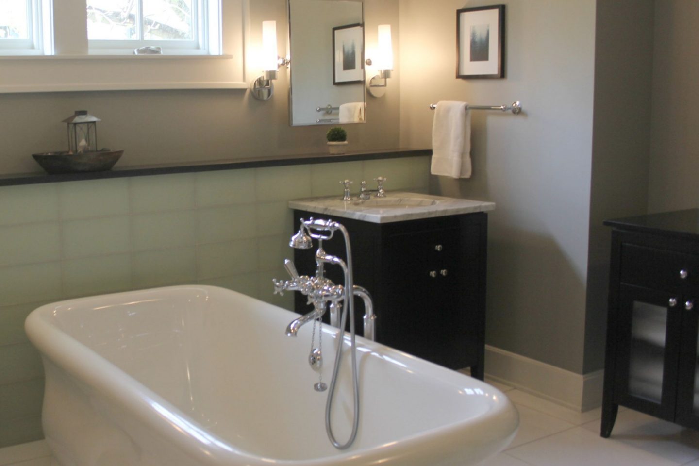 Luxurious modern bathroom with freestanding tub (Waterworks) and his and her sinks. Serene Spa-like Bathroom Design Ideas.