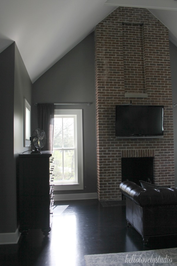 Red brick fireplace in lofty farmhouse bedroom. Modern Industrial Farmhouse Bedroom Design {2nd Floor Tour}. #modernfarmhouse #bedroom #industrialfarmhouse #greywalls #luxuriousfarmhouse #benjaminmooreplatinum #benjaminmoorestoningtongray