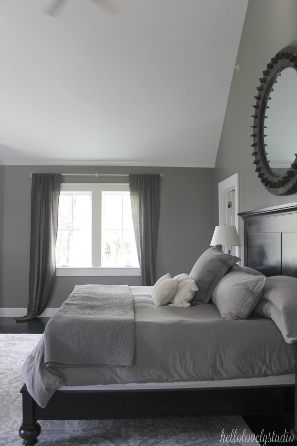 Serene and minimal interior design inspiration from an industrial farmhouse style bedroom with Benjamin Moore Platinum Gray paint color on walls. Photo: Hello Lovely Studio.