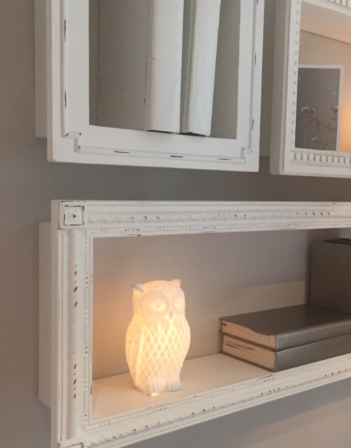 Vintage style shelves with mixmatched frames on wall. Owl nightlight. RH Chicago.