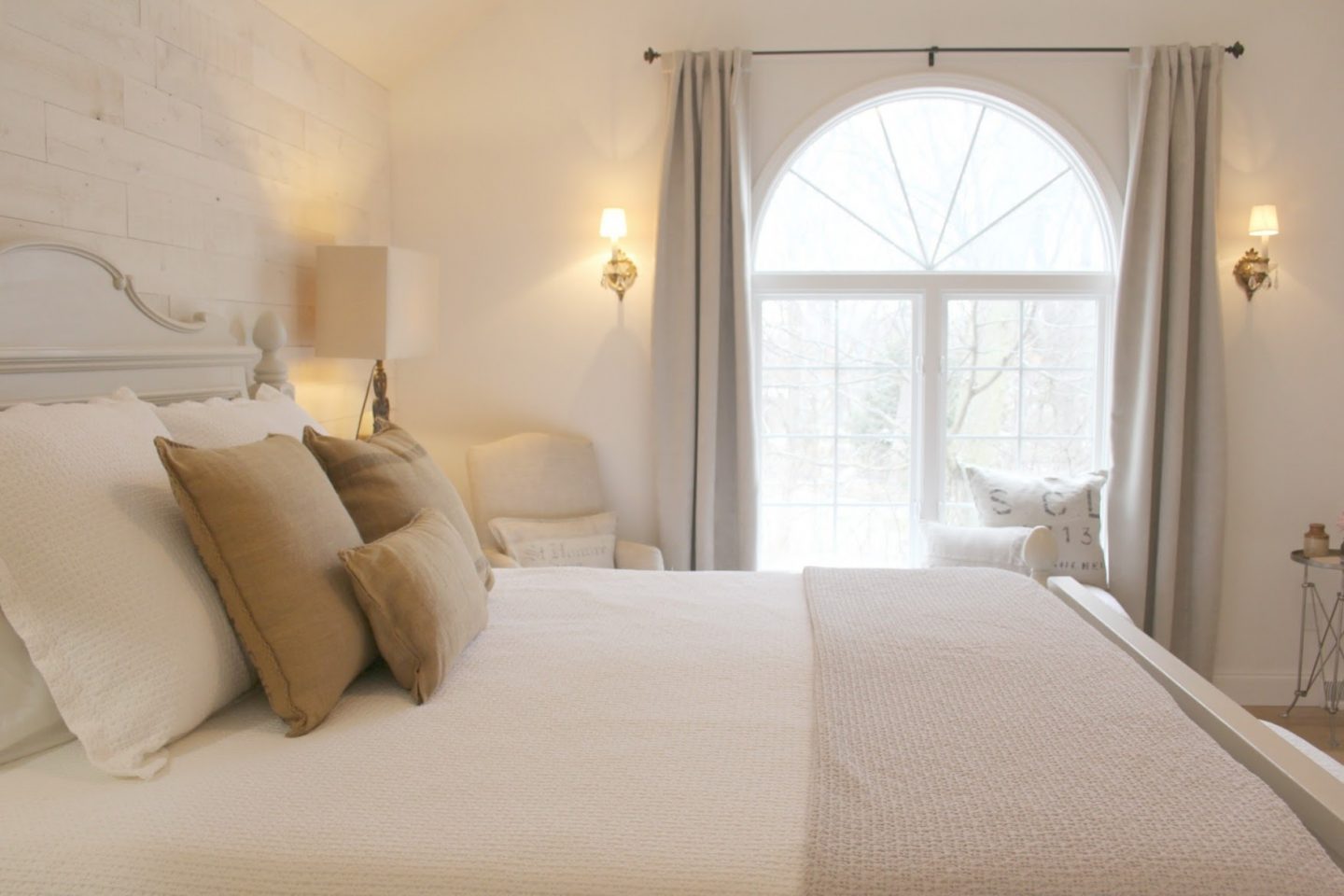 Nordic French white bedroom with light grey, linen, and white. Stikwood on wall, alder doors, cottage style furniture, and white oak flooring. #hellolovelystudio #bedroom #frenchcountry #nordicfrench #stikwood #serene #romantic #whitebedroom