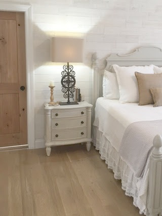 Nordic French white bedroom with light grey, linen, and white. Stikwood on wall, alder doors, cottage style furniture, and white oak flooring. #hellolovelystudio #bedroom #frenchcountry #nordicfrench #stikwood #serene #romantic #whitebedroom