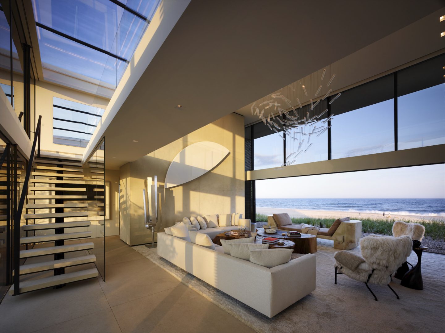 Modern living room of oceanfront home. A wall of glass rises in the air to eliminate any separation from the outdoors. #beachhouse #oceanfront #housedesign #livingroom #modernarchitecture