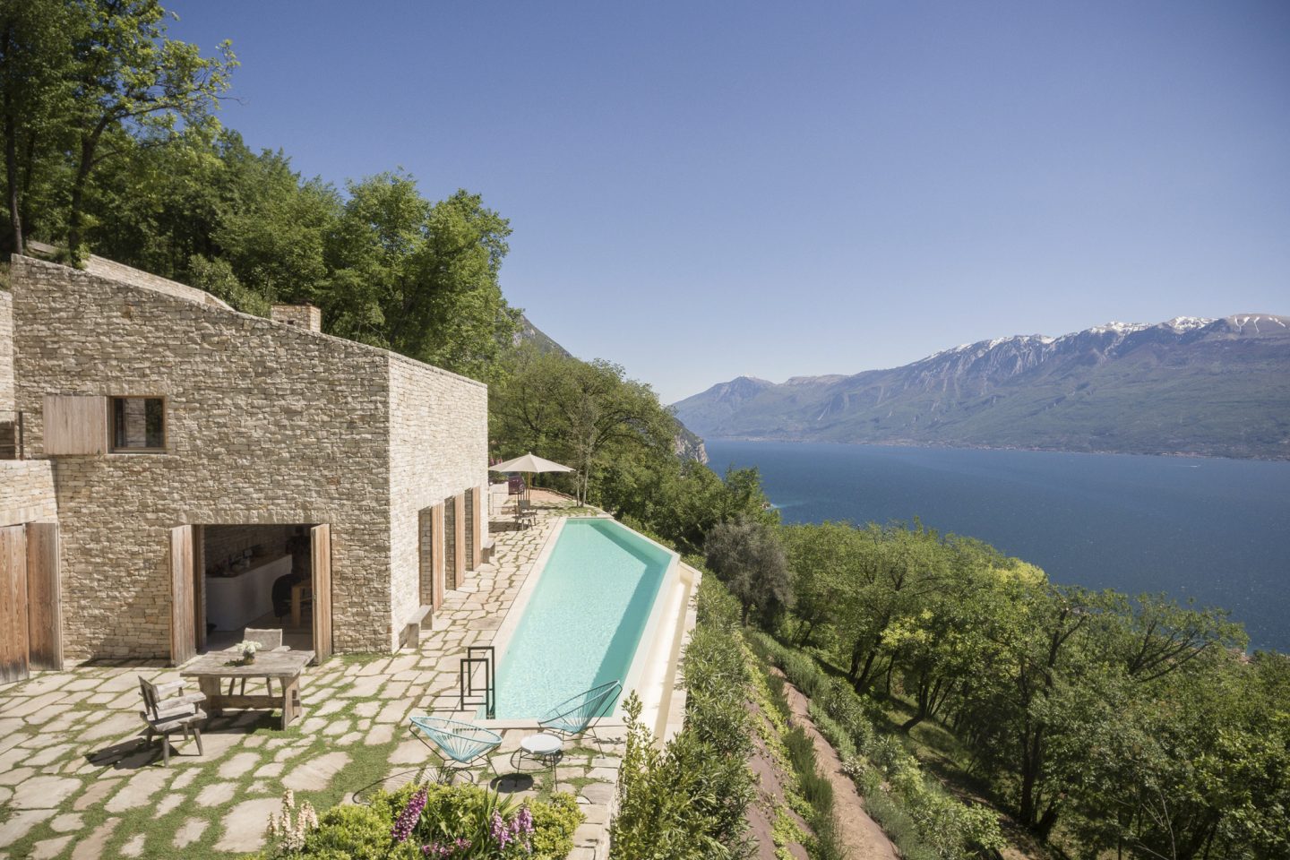 Breathtaking waterfront stone house with pool. #waterfront #housedesign #architecture