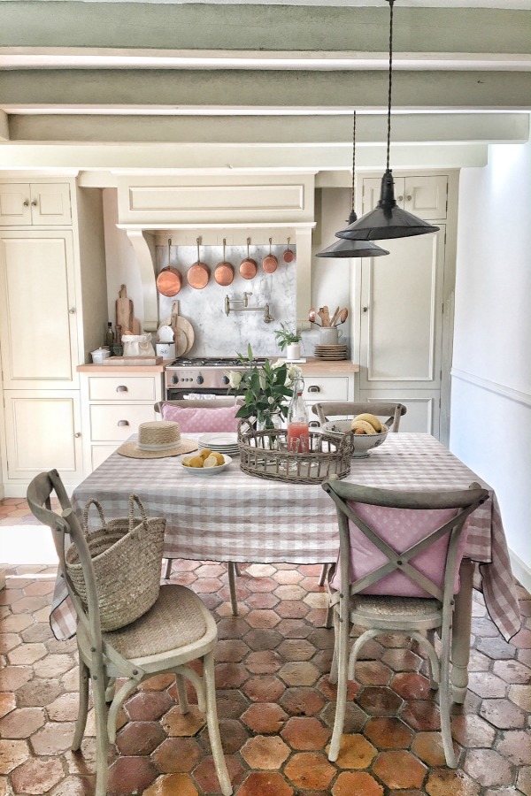 Terracotta hexagon tiles in a kitchen in France. French farmhouse design inspiration, house tour, French homewares and market baskets from Vivi et Margot.