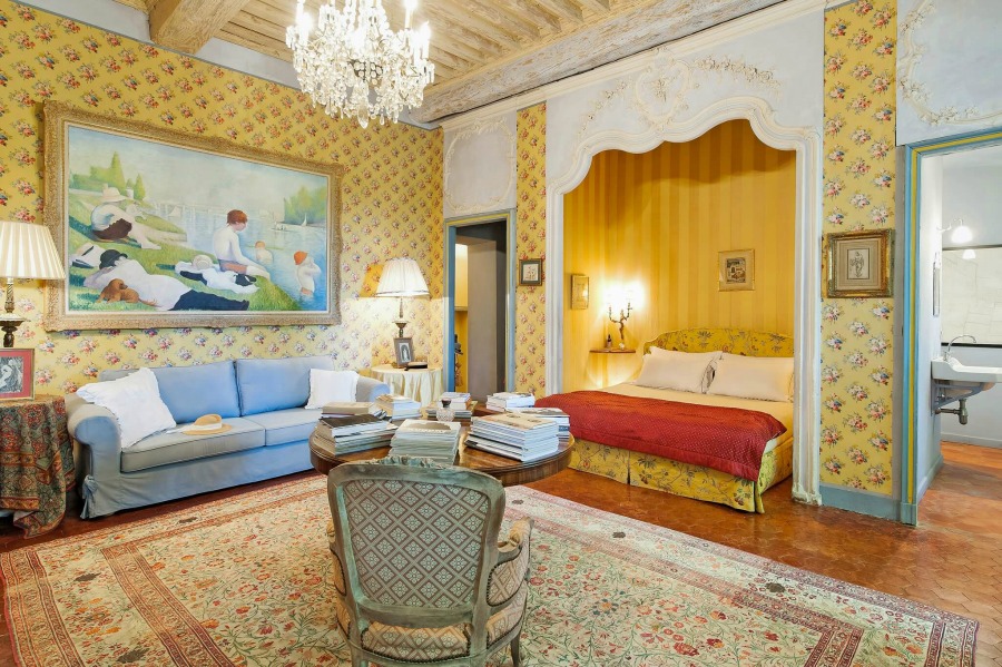 Bright and cheerful traditional style French country colors of blue and yellow in a stunning bedroom with crystal chandelier in a Provence chateau - Haven In.