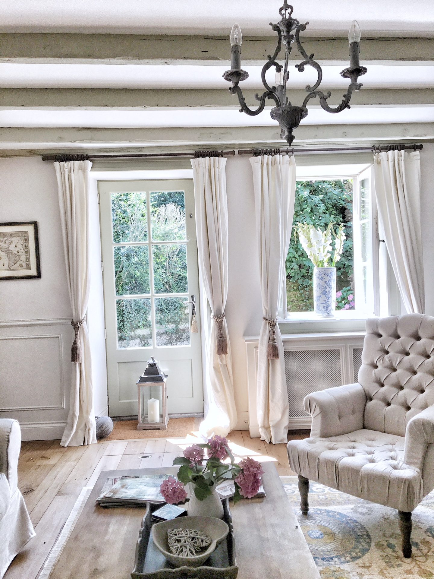 White living room in a French farmhouse near Bordeaux by Charlotte Reiss of Vivi et Margot.